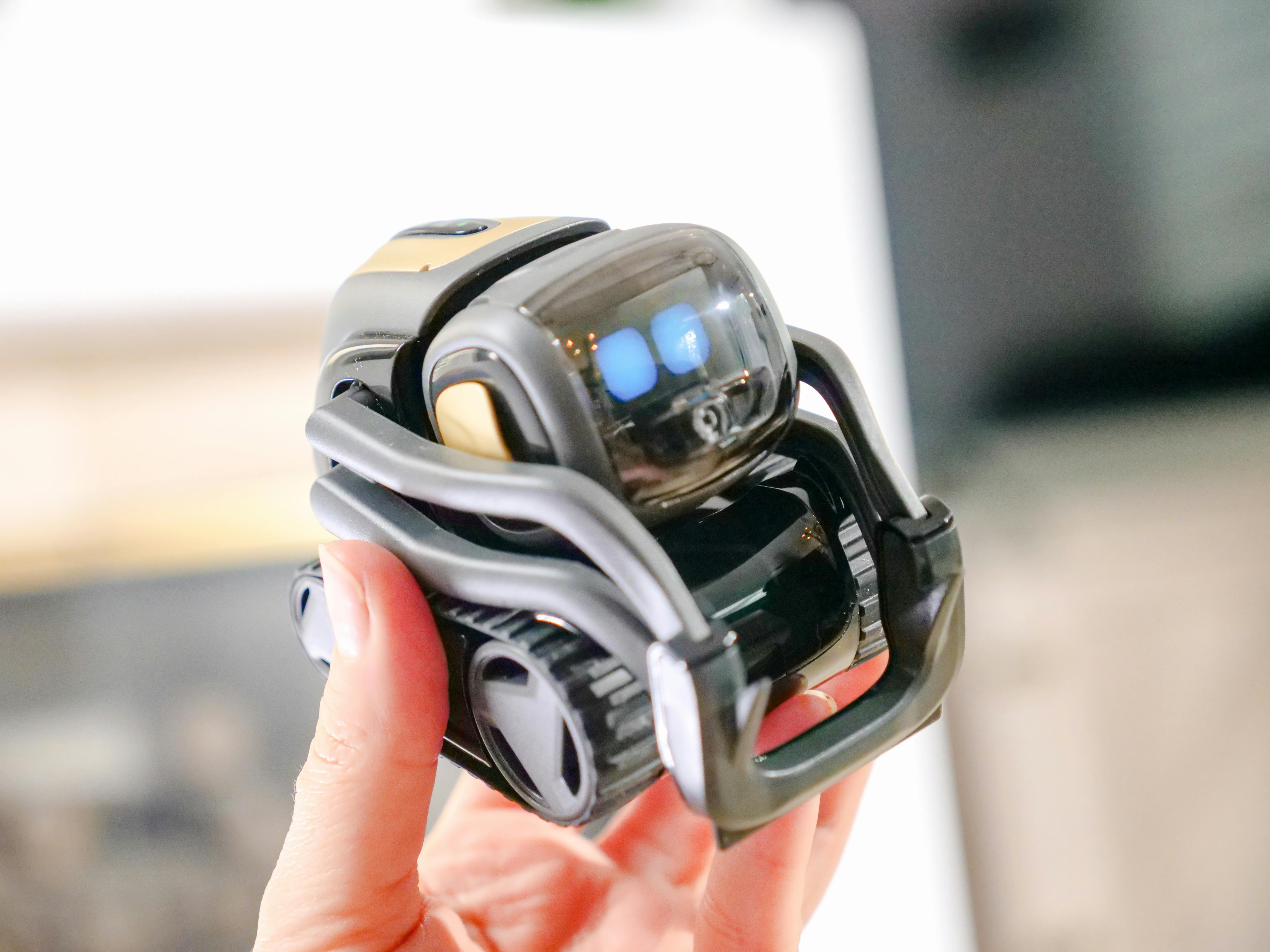 person holding miniature robot toy