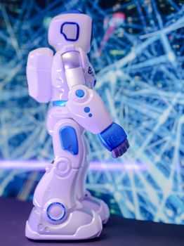 Side view of a futuristic humanoid robot with luminescent design and electronics theme.