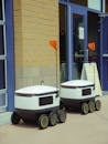 Automated Delivery Robots beside a Brick Wall