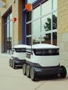 Delivery Robots Parked Beside Building
