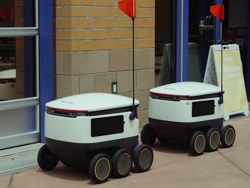 Delivery Robots Parked Beside Building