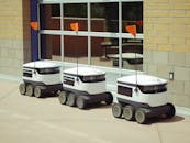 Delivery Robots Parked Beside Glass Window