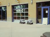 Delivery Robots Parked Beside Building