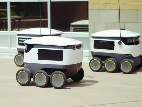 Free Advanced autonomous delivery robots in an outdoor urban setting, showcasing modern technology. Stock Photo