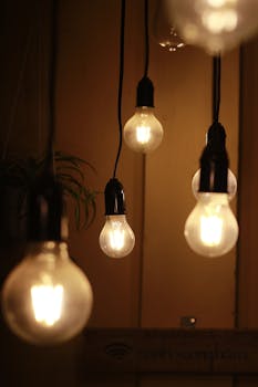 Warm ambient light from hanging bulbs creates a cozy interior atmosphere.