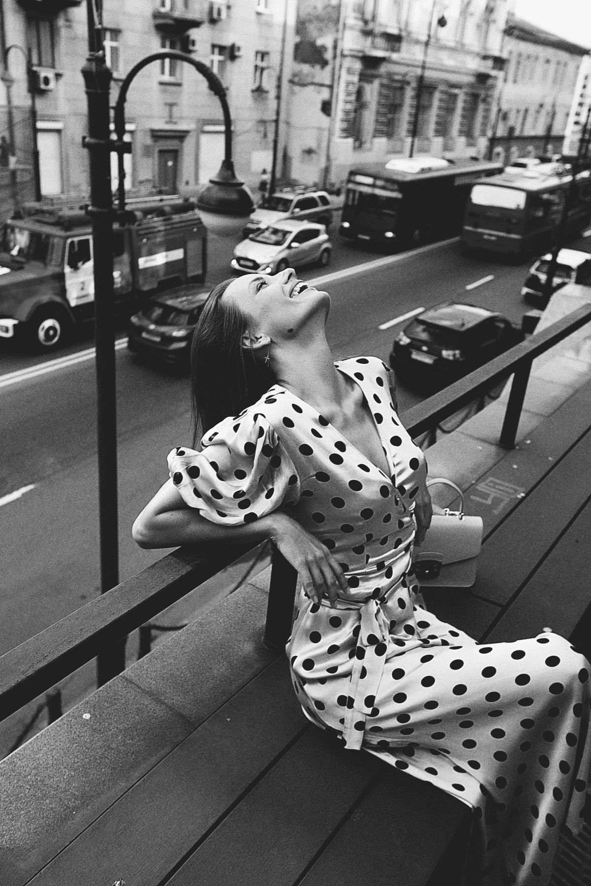 Black and white photo of a woman wearing a polka dot dress — timeless and chic