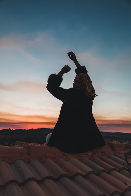 Person Sitting on a Roof