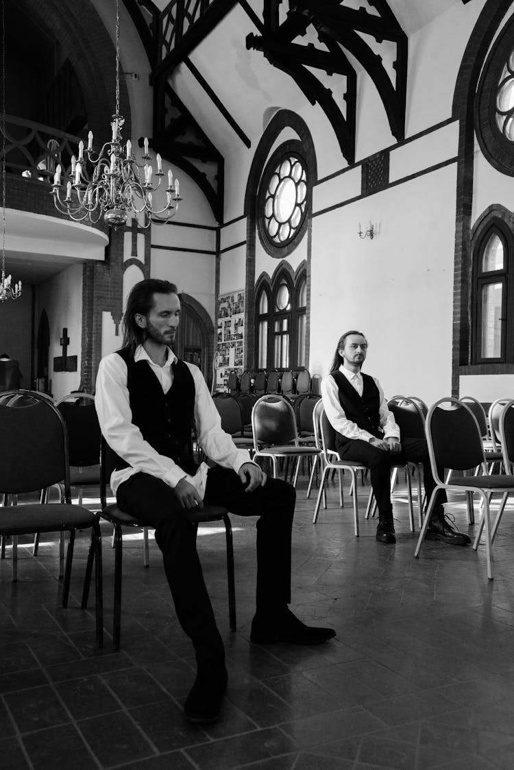 A Twin Men Sitting On The Chair