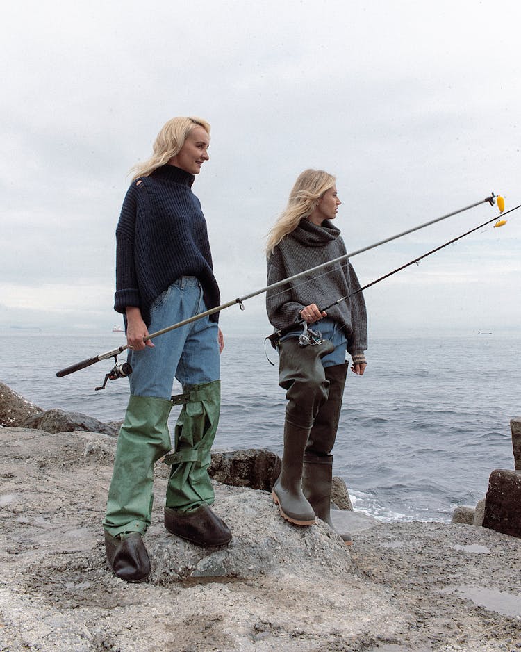 Women Wearing Rubber Boots Holding Fishing Rods