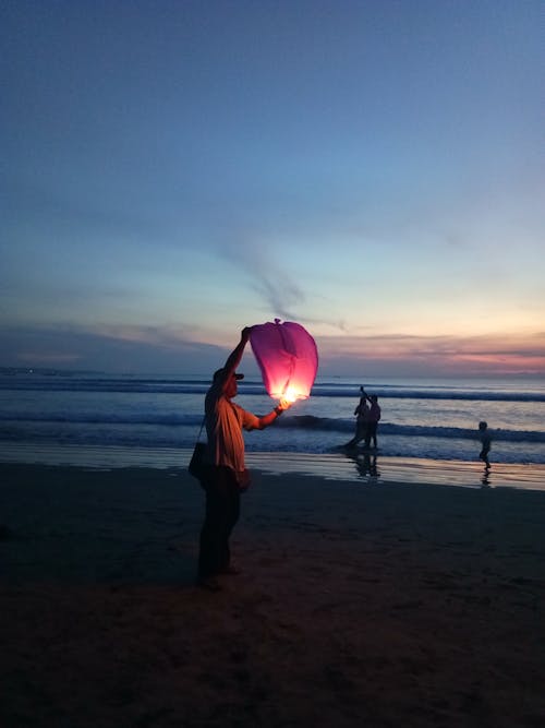 Man with Lantern on Beach