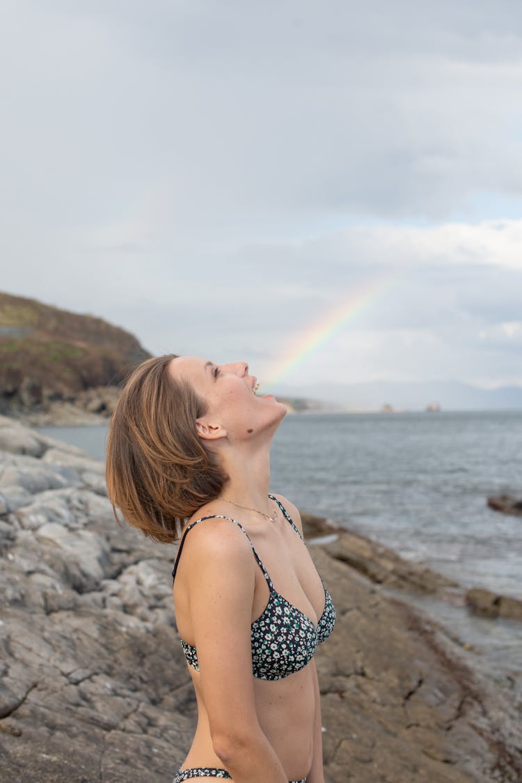 Woman With Mouth Opened Against Rainbow