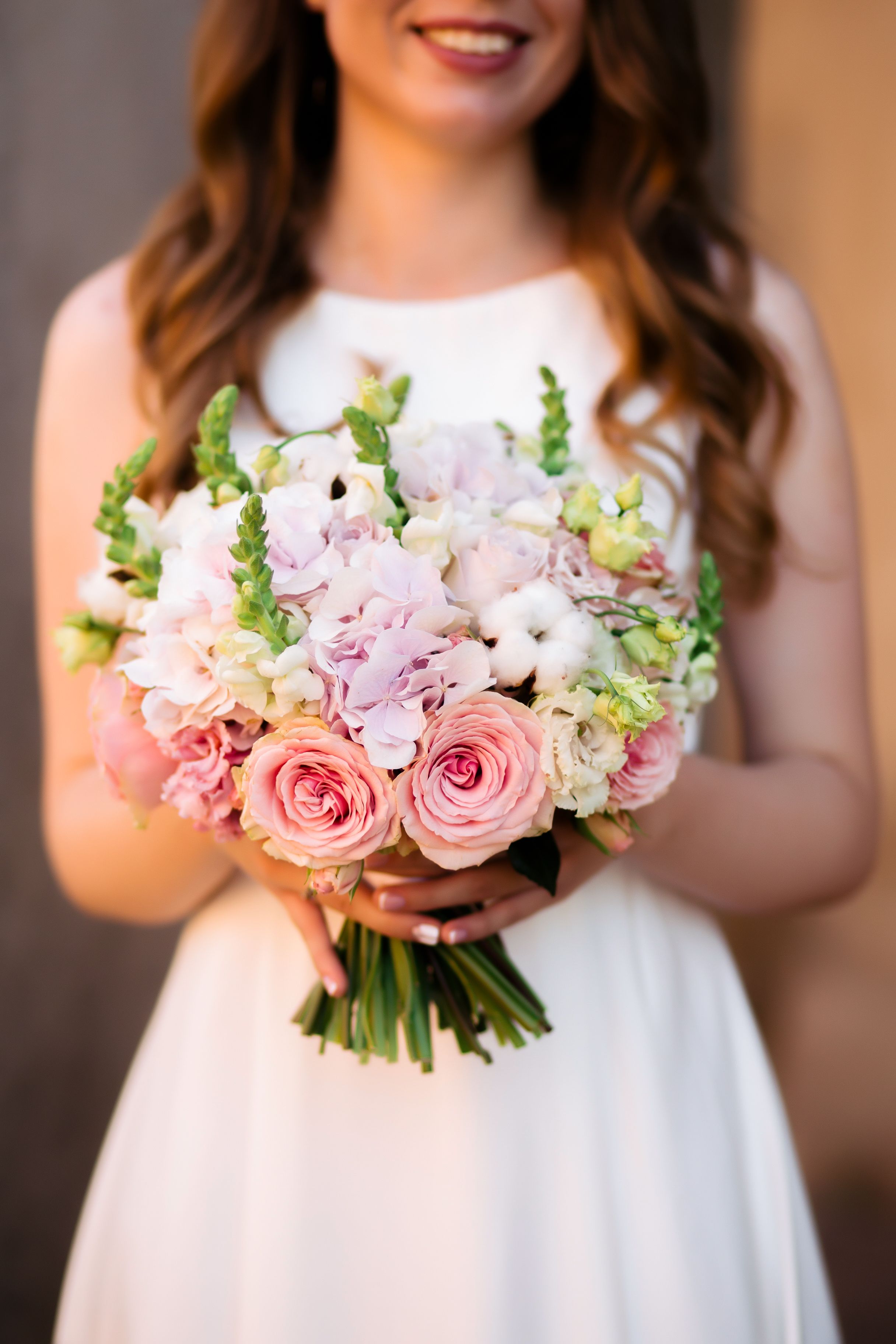 Woman In White Dress Holding A Bouquet Of Flowers · Free Stock Photo
