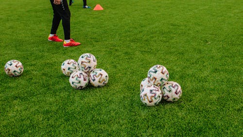 Set of Balls on Green Grass Field
