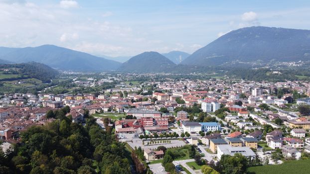 Stunning aerial shot of Feltre, Italy with lush hills and vibrant townscape.