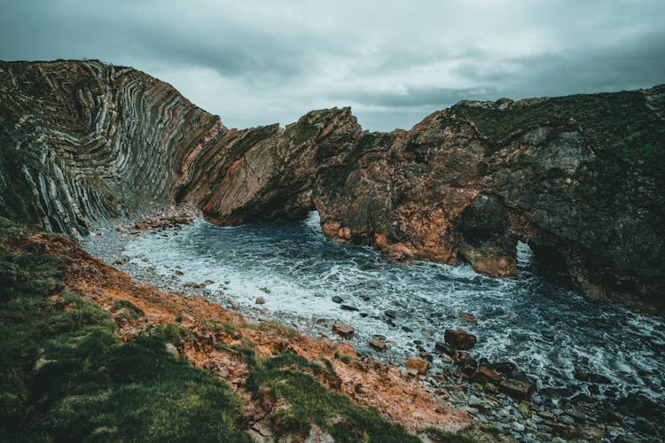 Brown And Black Rock  Formation On Water