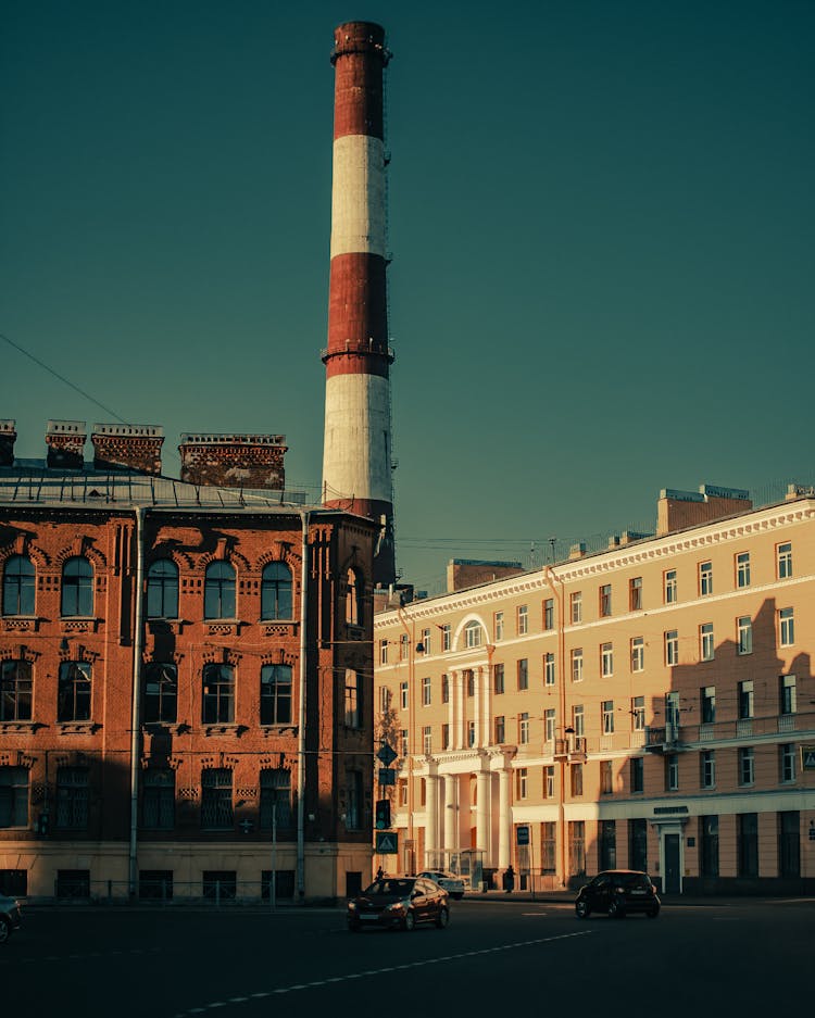 Red And White Factory Chimney Under Blue Sky