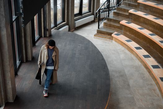 Person Walking on Gray Wooden Stage