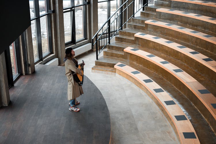 Man Standing On Gray Wooden Stage 