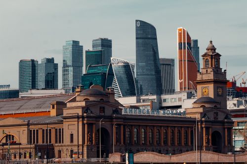 Free View of Moscow's modern skyline with the historic Kievsky railway station in the foreground. Stock Photo
