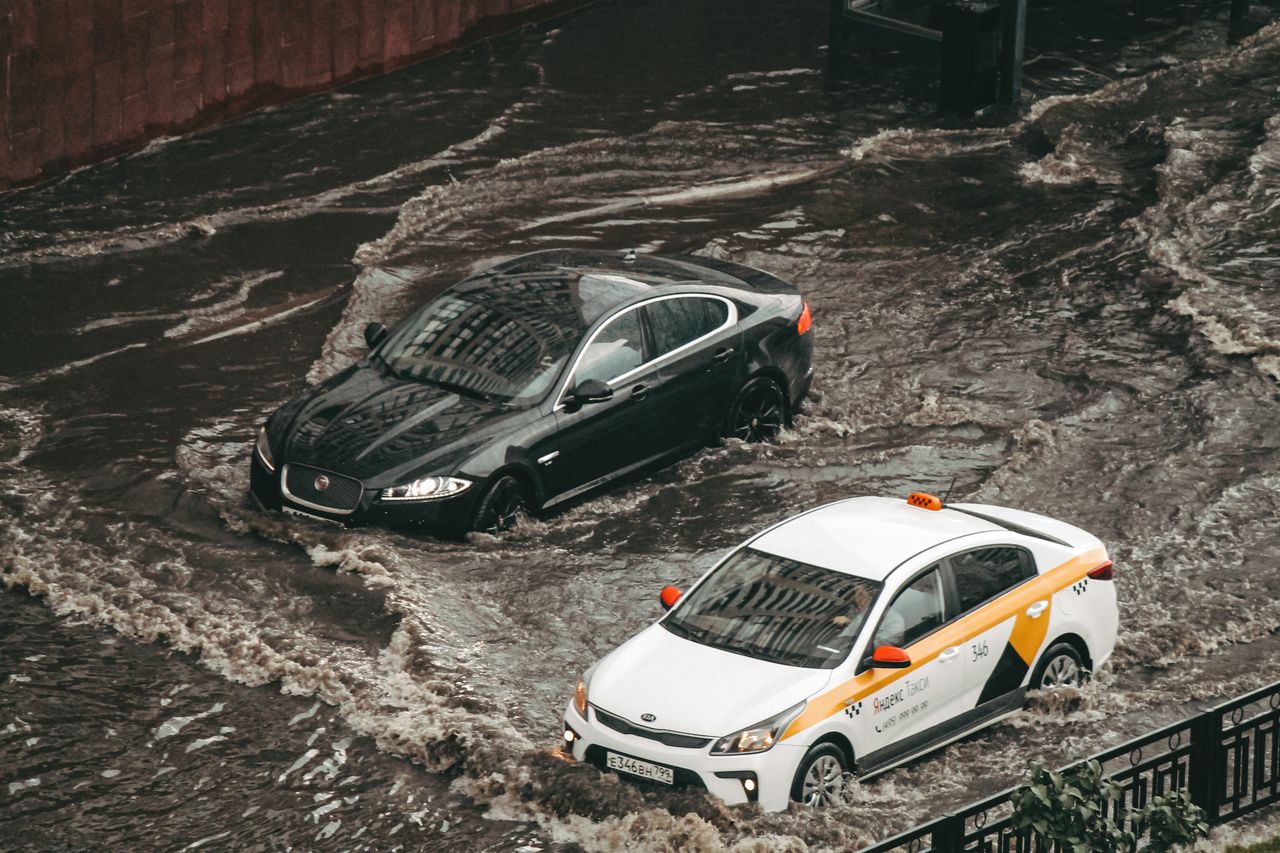 cars navigating through a flooded city street showcasing urban chaos a