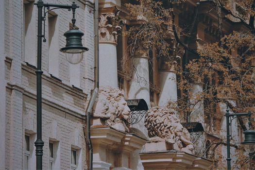 Close-up of a Building Facade Ornamented with Lion Head Sculptures 