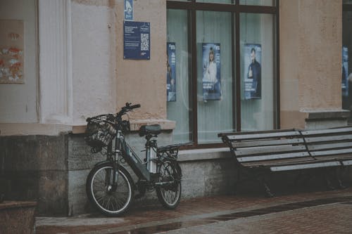 Photograph of a Bicycle Near Wooden Benches
