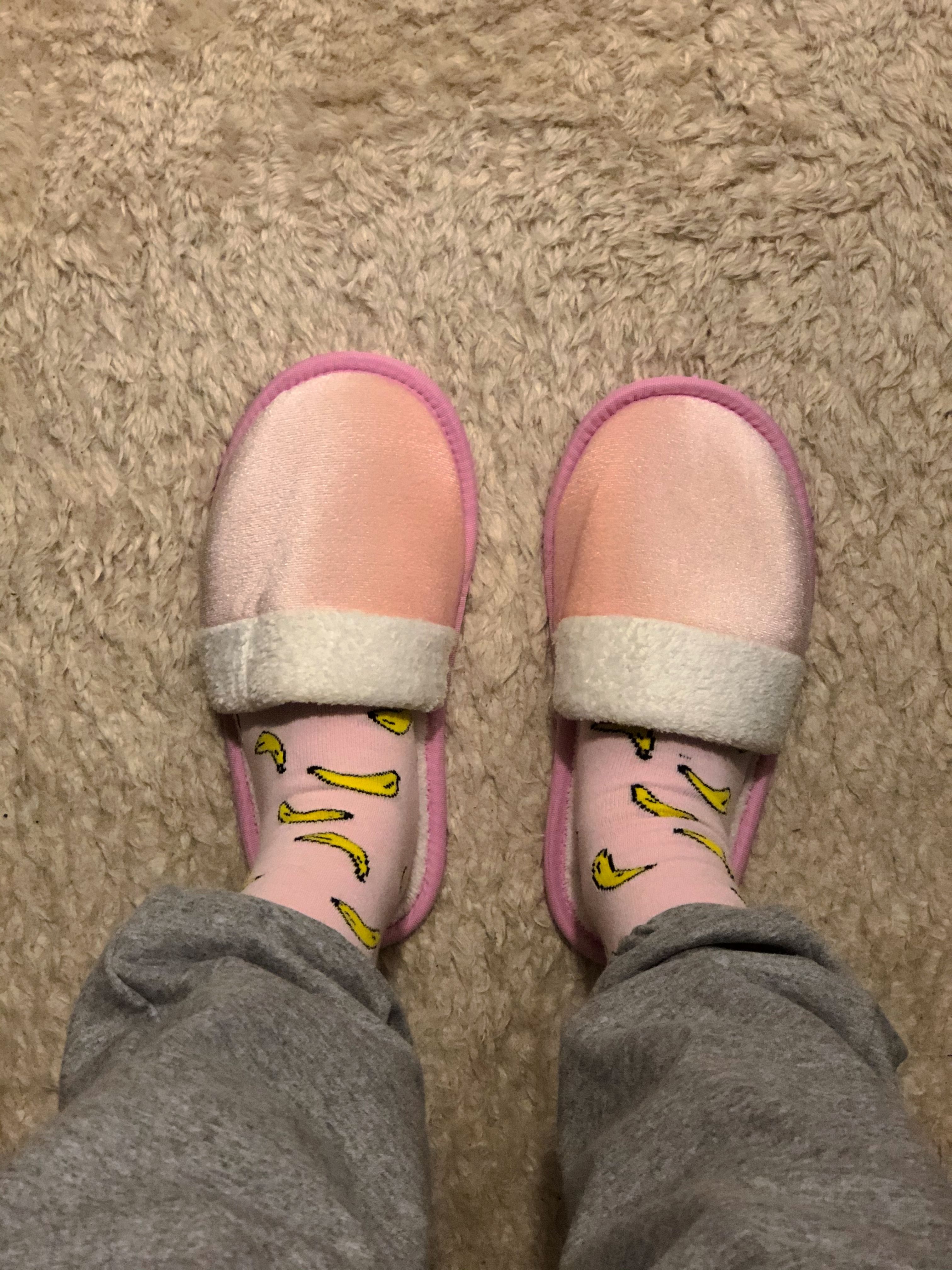 Person wearing soft pink slippers showing a roomy wide-width comfort fit