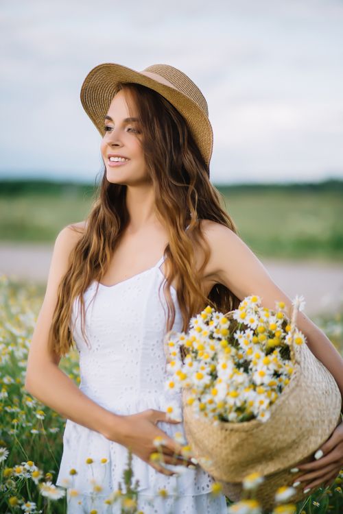 Woman in a Flower Field Wearing Straw Hat · Free Stock Photo
