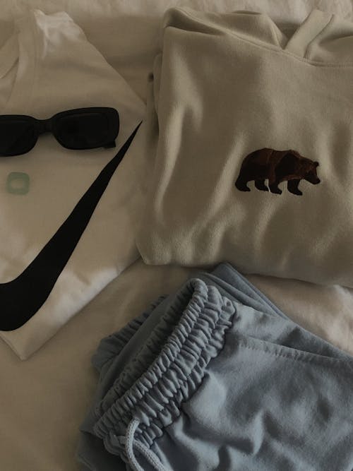 A Black Sunglasses Near the Cotton Clothes