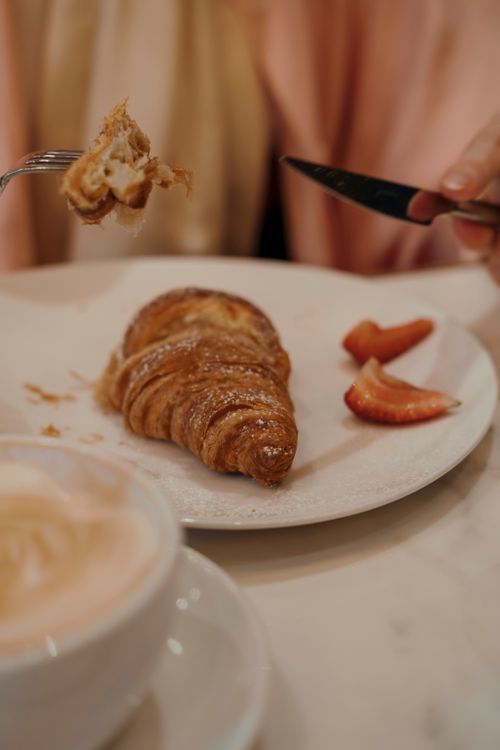 Free A fresh croissant served with strawberries and coffee, perfect for a cozy brunch. Stock Photo