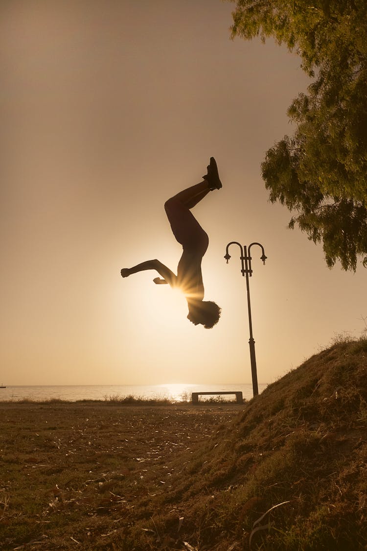 Silhouette Of A Person Doing A Backflip