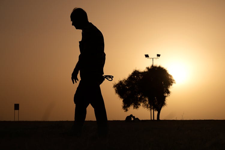 Silhouette Of An Elderly Person Walking 