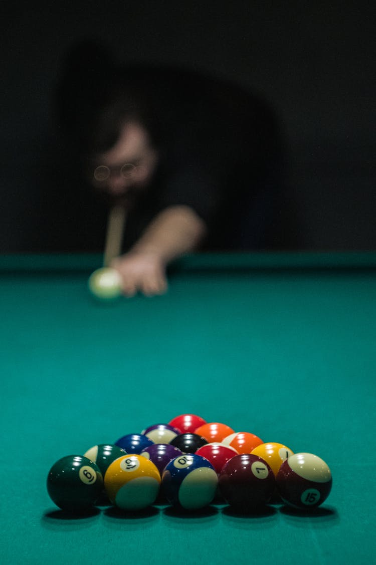 Person Making A Break Shot In Billiards