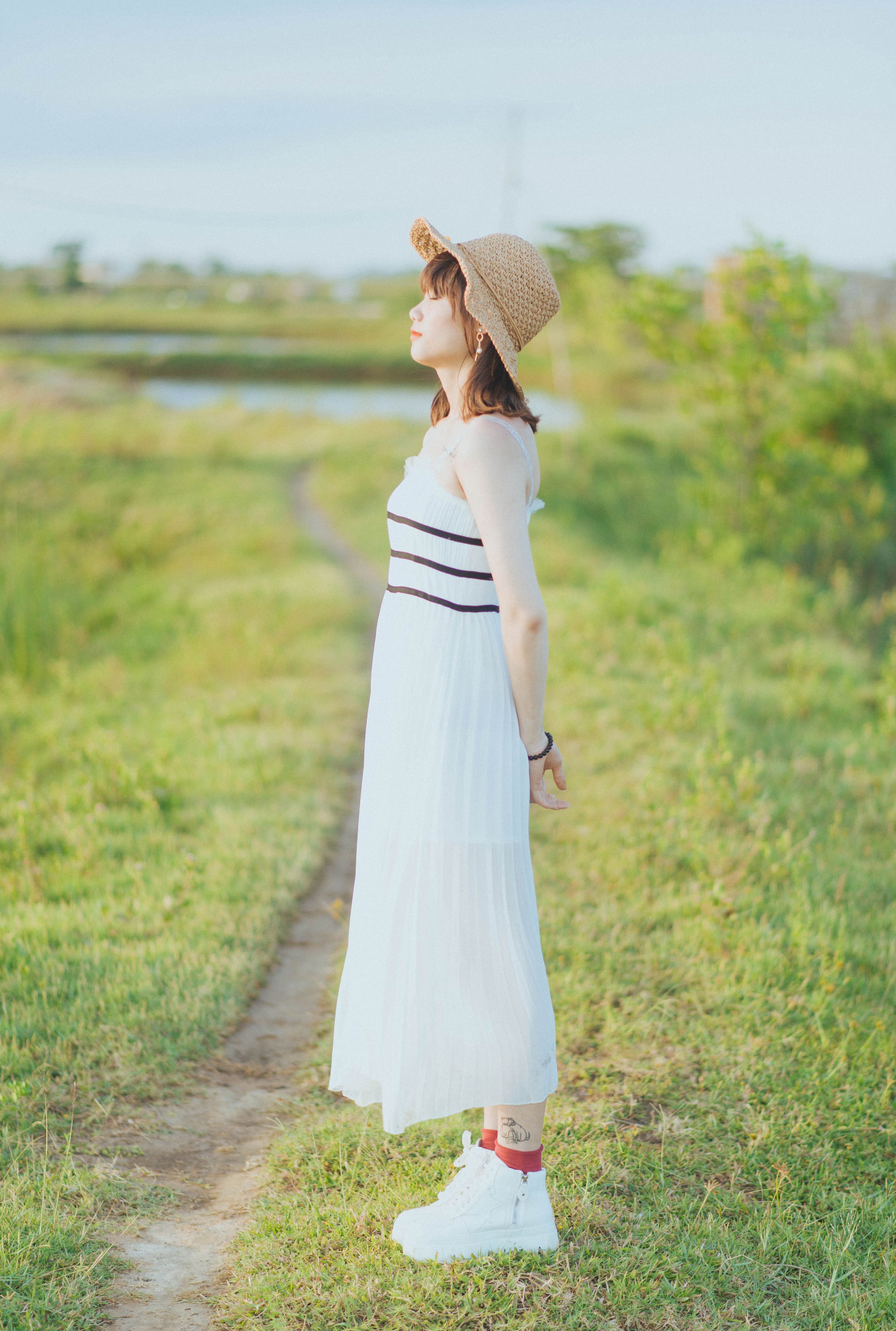 Woman in White Dress Standing on Green Grass Field · Free Stock Photo