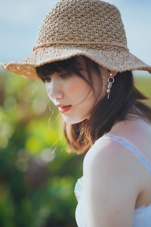 Close-Up Shot of a Pretty Woman Wearing a Sun Hat
