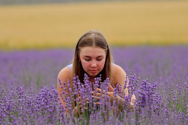 Photo Of A Woman Smelling Lavender Flowers