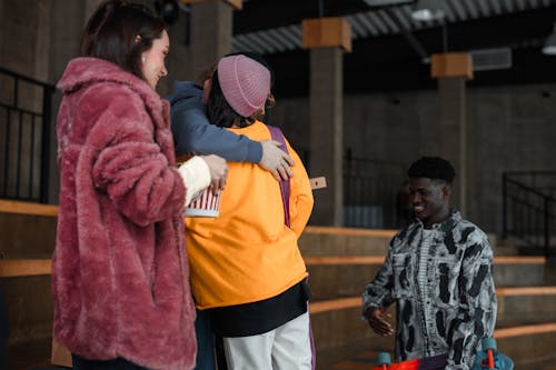 Two People hugging each other between Friends 