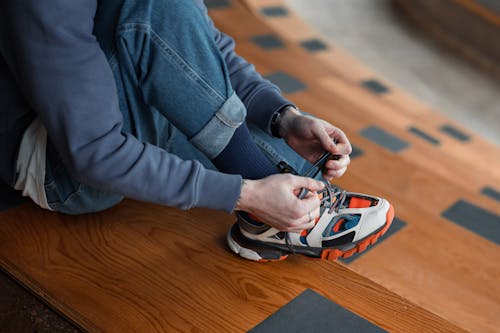 A Person Fixing Shoelace