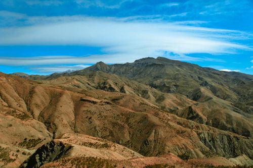 Free A breathtaking aerial shot of rugged mountains with a clear blue sky, showcasing nature's grandeur. Stock Photo
