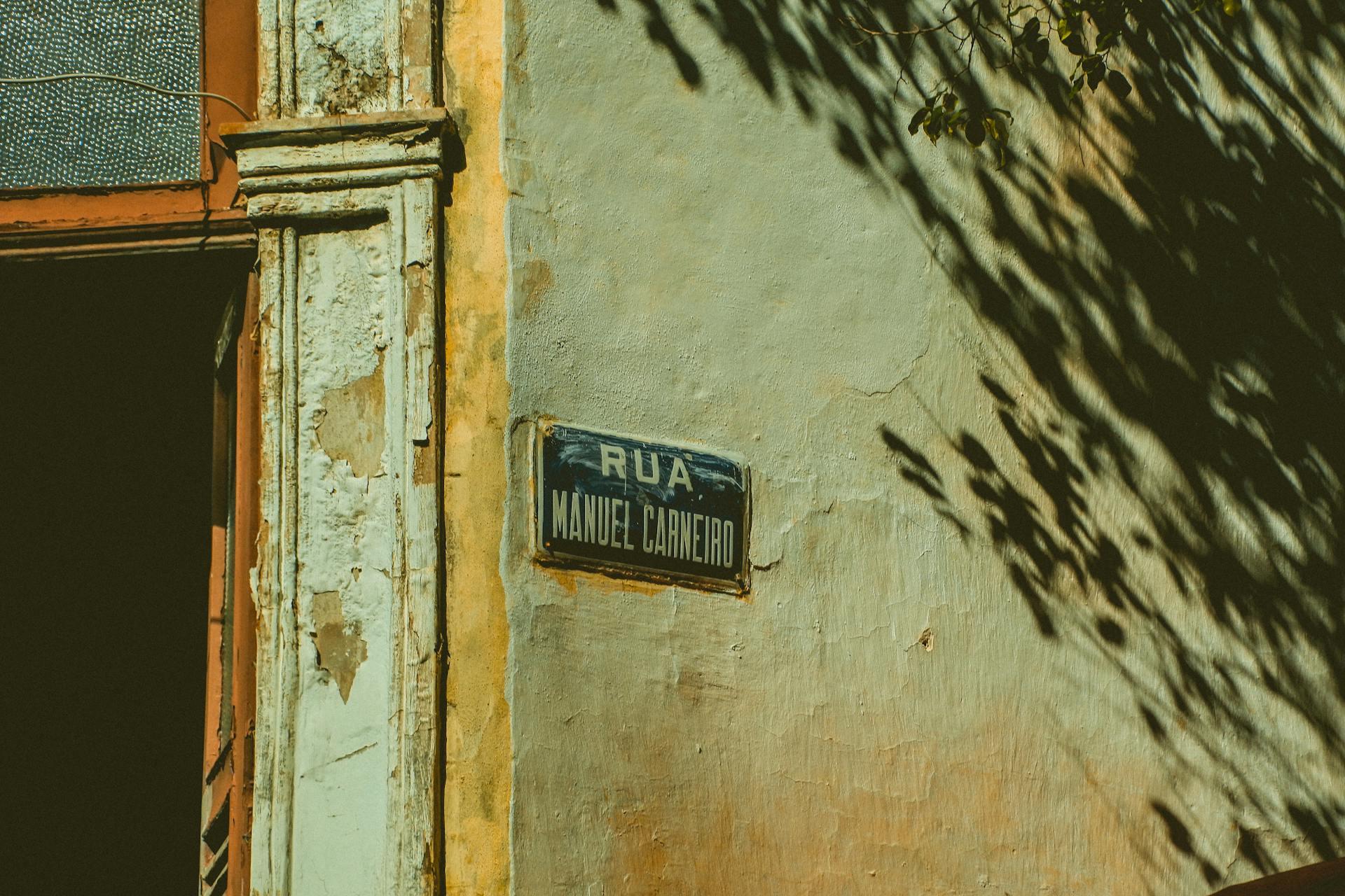 Close-up of a Street Name Plate on a Facade of an Old Building