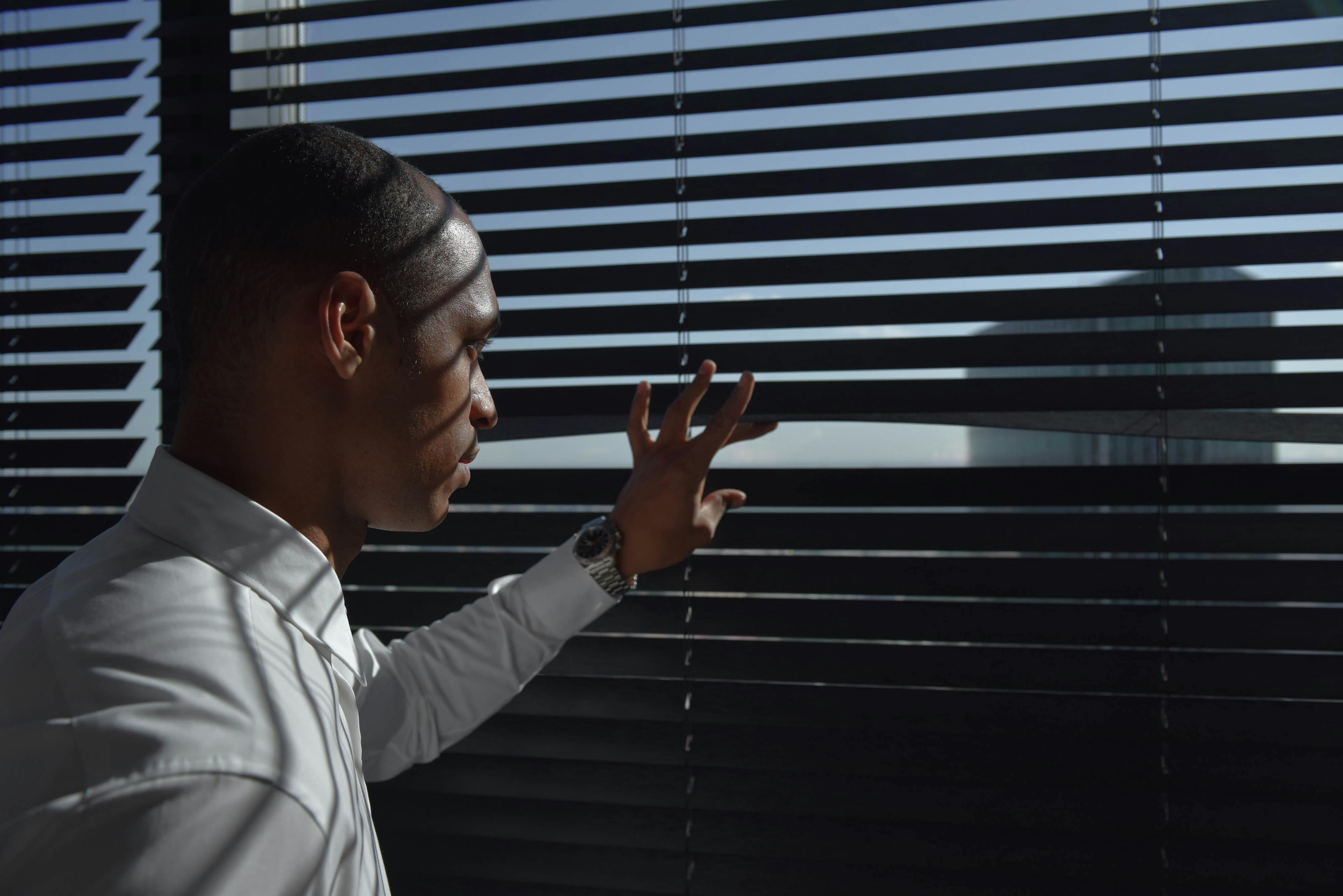 Photo of a Man Looking Outside of His Window · Free Stock Photo