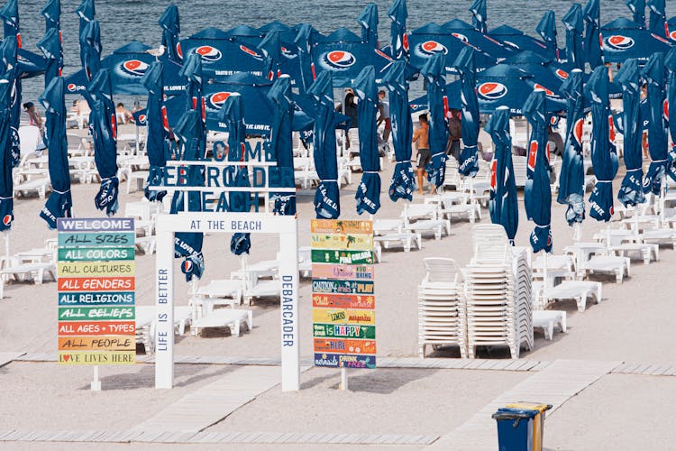 Entrance To A Beach Section With Umbrellas And Sunbeds 