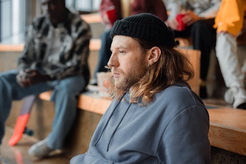 Side View of a Man with Facial Hair Wearing a Black Beanie