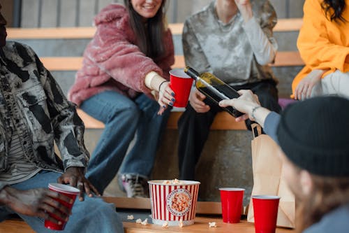 Friends Sitting, Drinking and Eating Popcorn