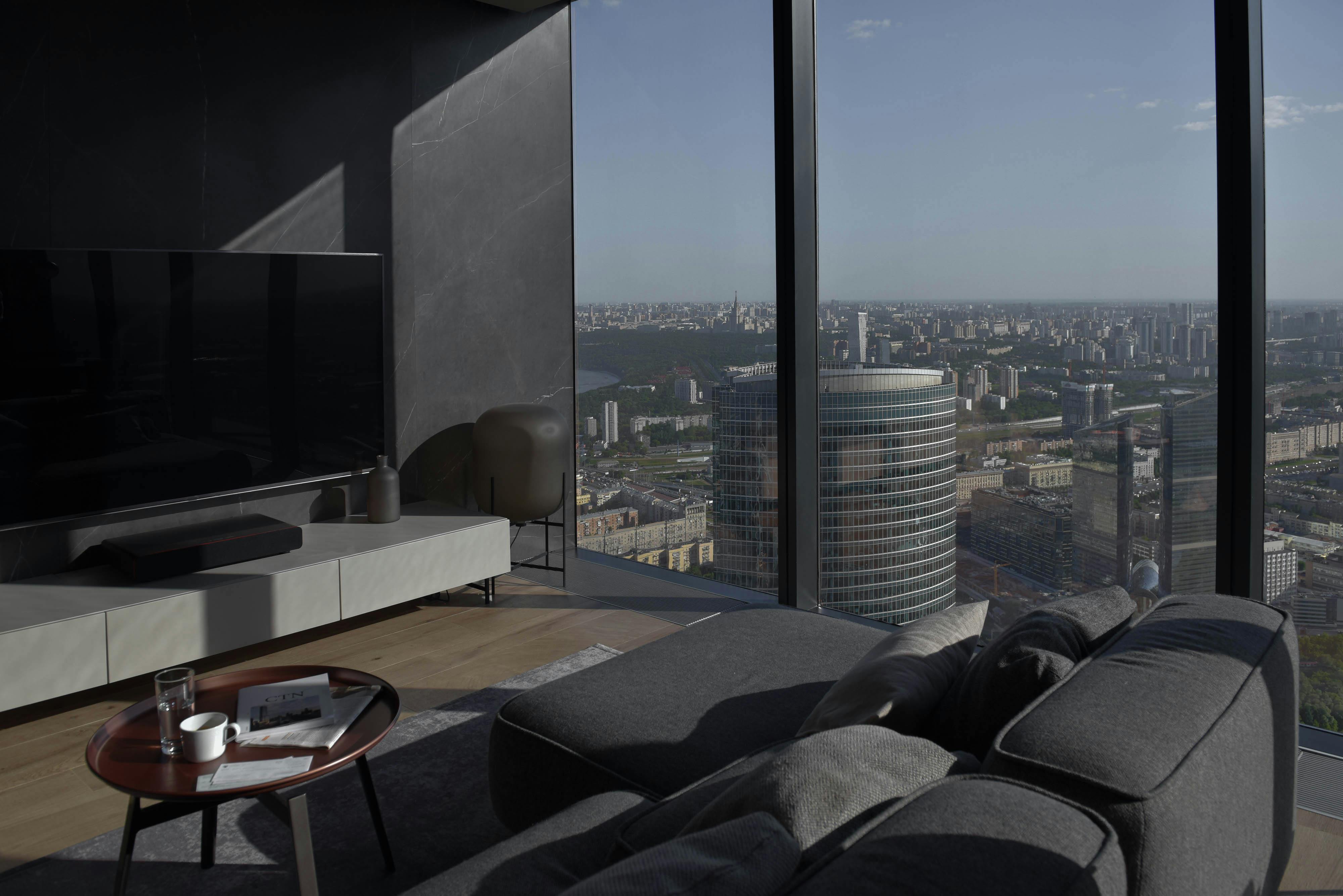 black and gray sectional couch beside glass windows