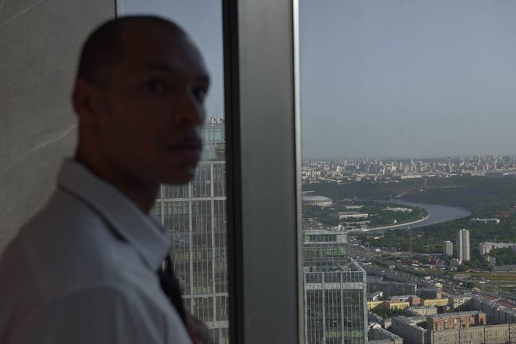 A  Man Standing Beside The Window