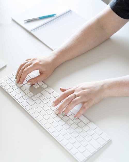 Free Close-Up Shot of a Person Typing on a Keyboard Stock Photo