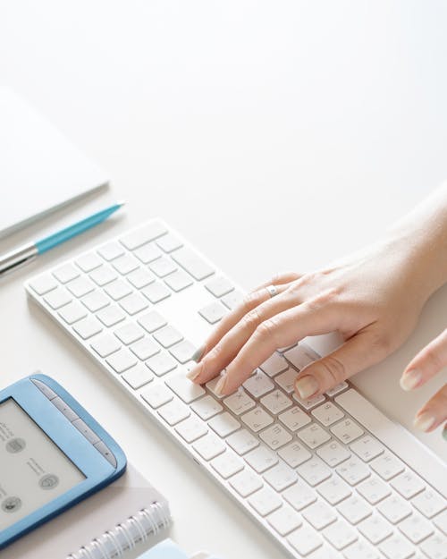 Free Person Holding White and Silver Apple Keyboard Stock Photo