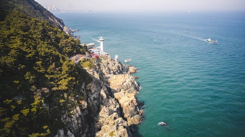 An Aerial Photography of a Lighthouse Near the Ocean