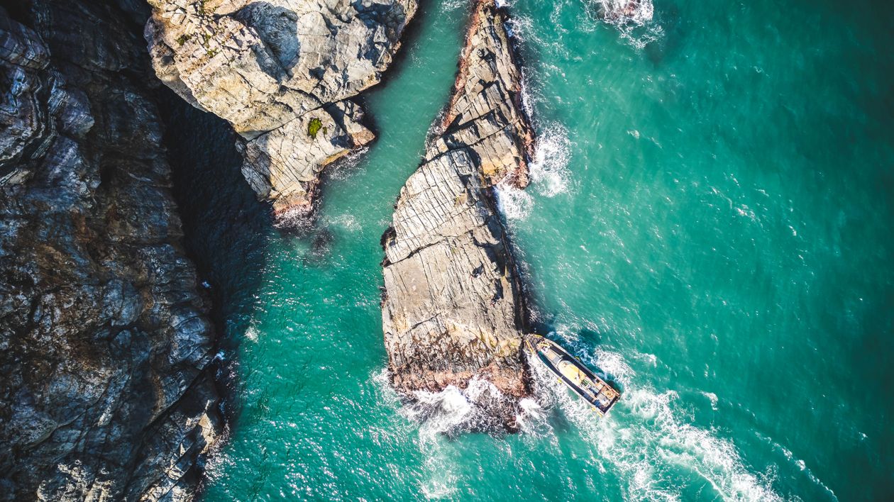 Aerial View of Watercraft Beside the Brown Rock Formation · Free Stock ...